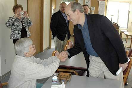 Rep. Rick Larsen shakes hands with Mary Jira at Wrobliski Manor in Arlington on March 5.