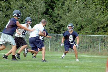 Arlington safety Jake Parduhn cuts off the right side of the practice field for assistant coach Davy Hudson