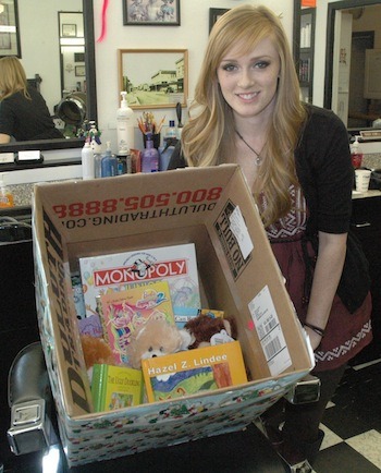 Magic Shears employee Jamie Johnson shows off some of the shop's collections for Cascade Valley Hospital's oncology department.