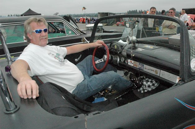Arlington street racer Tom ‘Big T’ McDonald relaxes in his hot rod customized 1956 Ford Thunderbird at the 10th annual Drag Strip Reunion and Car Show at the Arlington Airport on Sept. 14.