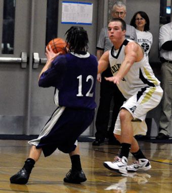 Arlington junior Bo Brummel attacks a Kamiak ball-handler at the top of the key.