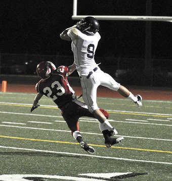 Arlington junior wideout Skylor Elgarico outjumps M-P’s Kyle Nobach to make a 50-yard reception.