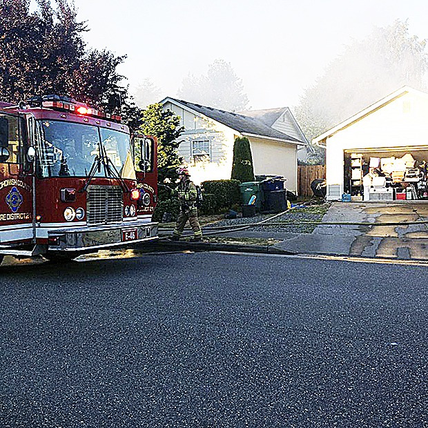 Firefighters work on the blaze in Arlington that displaced a family of three. The cause is unknown.