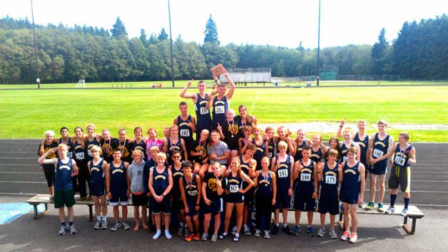 Arlington High School’s girls and boys cross country teams celebrate their recent victories at the South Whidbey Invite.