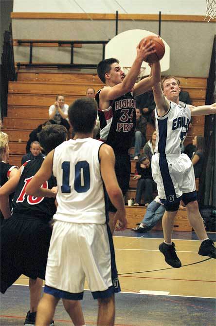 Senior guard Tim O’Kelly fights with Highline’s Calvin Wold for a rebound.