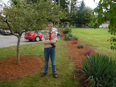 Lakewood High School’s Parker Yancey stands proudly in the Arlington Library grounds that he helped spruce up.
