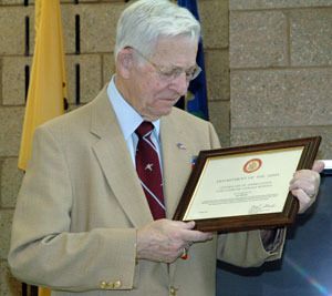 World War II veteran Leo Hymas looks at the Army Certificate of Appreciation for Patriotic Civilian Service that he received at the Marysville Armed Forces Reserve Center on April 13