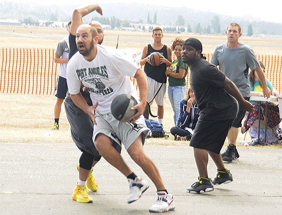 Rick Smith of Seattle makes a move under the basket during the 3-on-3 basketball tournament at the Arlington Airfield.