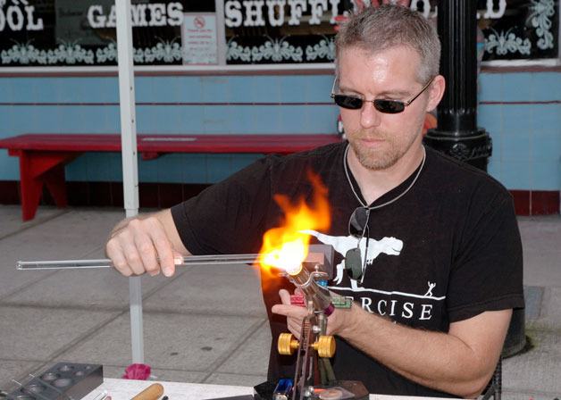 Marysville’s James Mills demonstrates how he makes his “Arcane Glass” artwork during last year’s Arlington Street Fair.