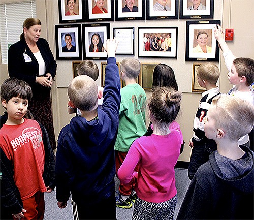 Arlington schools superintendent Kristine McDuffy gives students a tour of the district office.