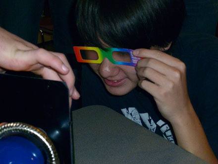 Lakewood High School student Sean Kustra dons special glasses at the University of Washington that demonstrate refraction of light