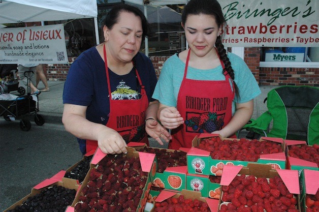 Biringer Farms' Janet and Megan Boers set out raspberries