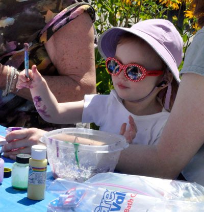 Sophia Blake tries her hand at abstract expressionism during the annual Youth Engaged in Art event on Saturday