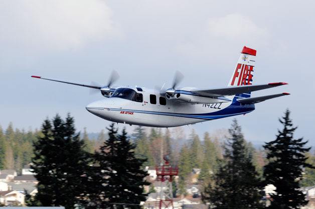 Marysville resident Brad Goldman's Twin Commander flies over a wildfire. Goldman spends his summers serving as an air attack specialist for the U.S. Forest Service and other government agencies.