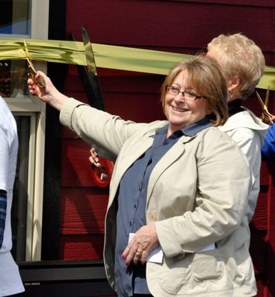 Arlington Mayor Barb Tolbert helps cut the ribbon on the new Arlington Depot visitor information center and restroom facility on April 28.