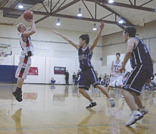 Senior guard Caleb Brown shoots for two against Grace Academy’s Jay Lee. Brown had eight points