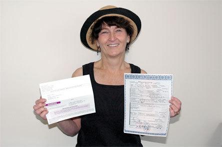 Arlington resident Billye Brooks-Sebastiani holds her husband's death certificate
