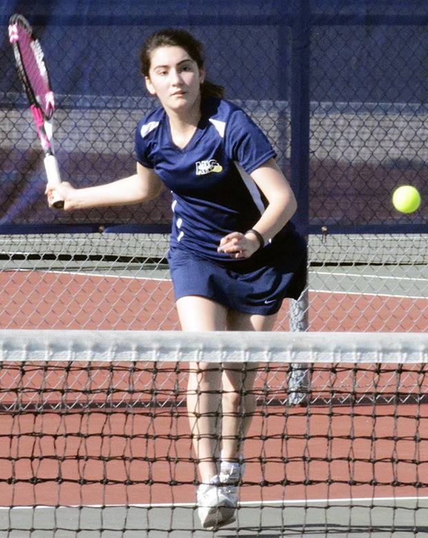 An Arlington singles player pursues the ball.