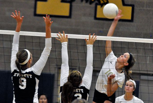 Arlington freshman Audrey Frolich goes for a kill over an Everett defender during the Eagles’ season opener Sept. 8.