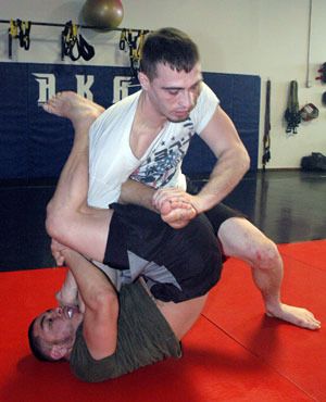 Brett Malon gains the upper hand over Carlos Rolon on the mats of the Arlington Kickboxing Academy on Jan. 12.