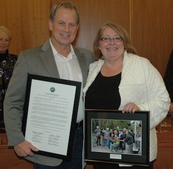 Outgoing Snohomish County Council member John Koster is honored by Arlington Mayor Barbara Tolbert and the Arlington City Council on Dec. 2.