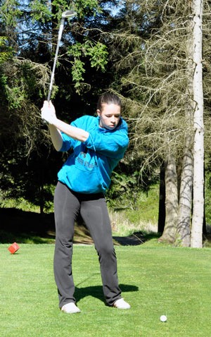Arlington’s Emmi Modahl practices her swing at hole nine on the Battle Creek Golf Course during a match on May 1.