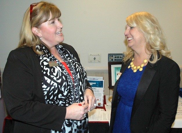 Marysville loan officer Kim Thompson and Claire Olsen of Lake Stevens talk shop at the Jan. 14 WISE Women Business Showcase in Smokey Point.