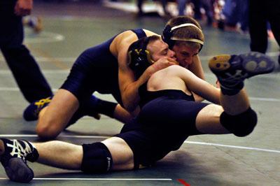 Arlington  wrestler Scotty Bardell takes down his opponent during the Wesco 4A District Tournament on Feb. 1.