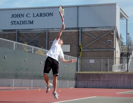 Arlington tennis player Brent Thompson slams a serve across the court.