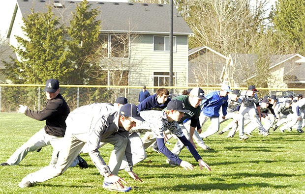 Arlington's baseball team hits the turf during its second day of tryouts.