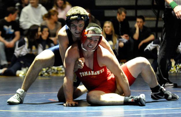 Arlington 145-pound junior Jesse Driscoll tries to work Marysville-Pilchuck junior Anthony Moffitt to the mat.