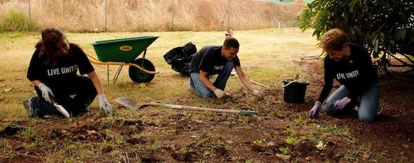 Volunteers from Senior Aerospace AMT do yard work for Sherwood Community Services as part of United Way's Days of Caring Sept. 21-22.