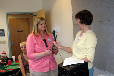 Laura Kuhl and Jean Olson display the Arlington Garden Club’s Myrtle Ruckert Award that was presented Monday