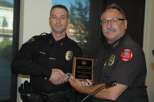Detective Mike Sargent received the title of Arlington Police Department Employee of the Year for 2013 from city Public Safety Director Bruce Stedman.