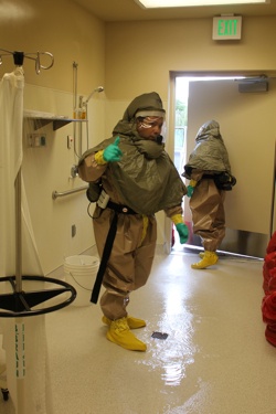 EMS personnel are decontaminated at Cascade Valley Hospital in Arlington after exposure to tear gas in Darrington on April 28.