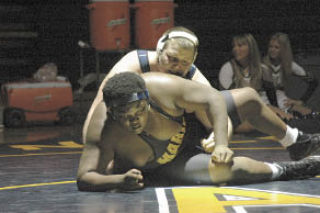 Arlington senior Bryant Dickerson ties up his team with a pin over Mariner early in the teams’ Dec. 11 meeting.
