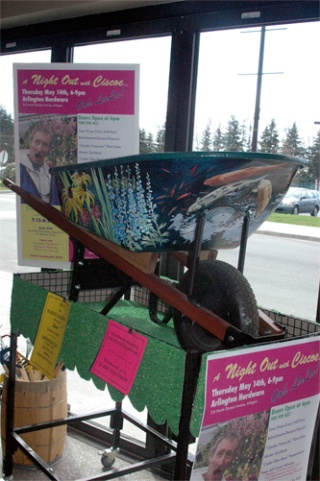 A wheelbarrow painted by local artist Harry Engstrom is among the many very special items that will be raffled off at the upcoming “Night with Ciscoe Morris” at Arlington Hardware Thursday
