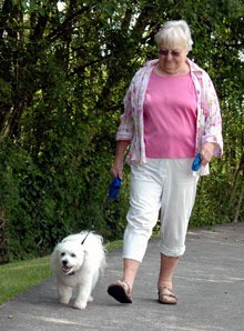 Arlington resident Tynoccia Goodwyn walks her 2-year-old bichon frise