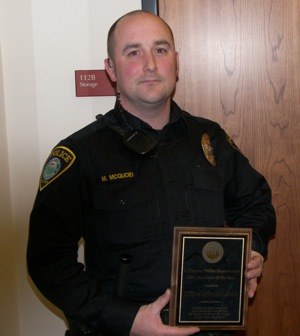 Arlington Police Officer McQuoid receives a plaque naming him the Arlington Police Department's Employee of the Year for 2010 on Jan. 18.
