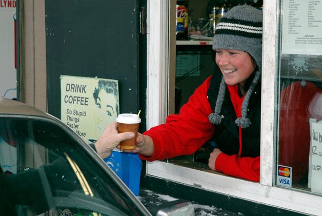 Triple Shot espresso stand owner Jamie Ryker hands a passing motorist a hot beverage on the afternoon of Nov. 24.