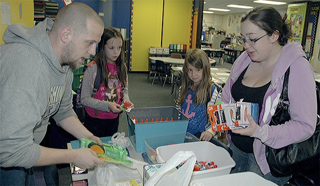 Bryan White and his wife Cassie gather up school supplies for fifth-grader Audrey and second-grader Caitlyn at the first day of school Sept. 8 at Lakewood Elementary School.