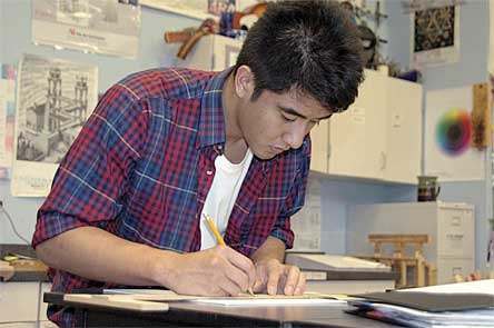 Arlington High School senior Nikko Azucena works on a logo in art instructor Bev Schatz’s classroom Feb. 16.