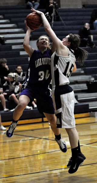 Arlington sophomore Lindsay Brown blocks Abby Molstre in the second half.