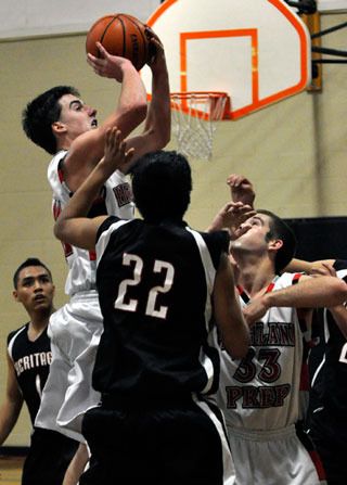 Calvin Wold shoots a jumper in the paint amid three Tulalip defenders. Wold finished with 21 points and 13 rebounds.