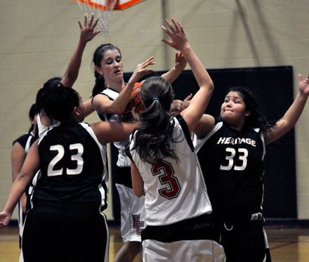 Highland Christian forward Jade Olin fights with a pair of Tulalip Heritage players for a rebound in the second half.