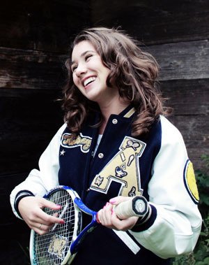 Arlington High School senior Kelsey Ghirardo jokes around with her tennis racket. Ghirardo is one of the top tennis players in the district and also an academic success at AHS.