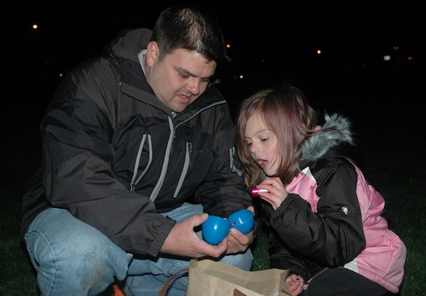 Danial Wanke elicited awe from daughter Alyssa as he cracked open her plastic prize eggs during the Flashlight Easter Egg Hunt for last year's Arlington Relay For Life.