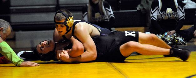 Eagle 160-pound senior Shawn Berg seeks a pin against Knights freshman Conner Mitchell.