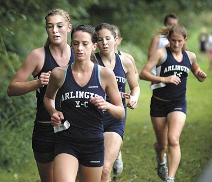 The Arlington girls varsity team push one another by running in a pack on Sept. 16.
