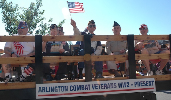 Arlington combat veterans from World War II through the present receive cheers from the crowds lining Olympic Avenue during the 2012 Fourth of July Grand Parade.